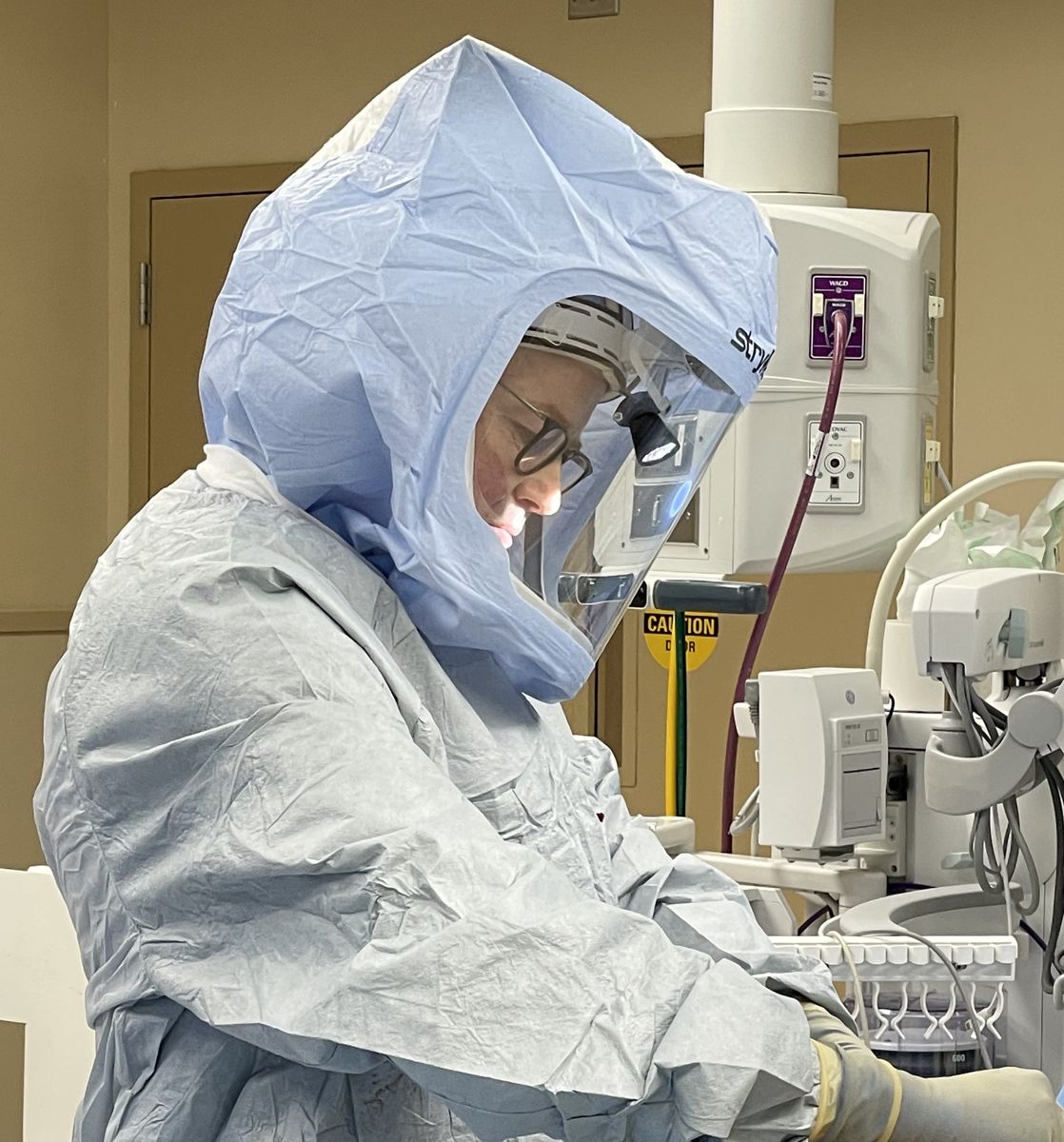 Dr. Olsen at work during surgery, seen from the side